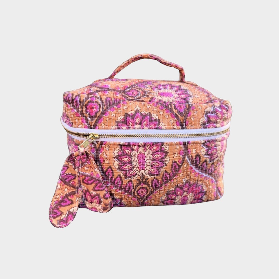 BUÍS STUDIO quilted makeup bag with bohemian mandala print in peach, pink, purple, and burgundy. Features a top handle and zip closure.