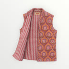 BUÍS STUDIO reversible cotton vest in orange, pink, and purple with a floral print on one side and stripes on the other.